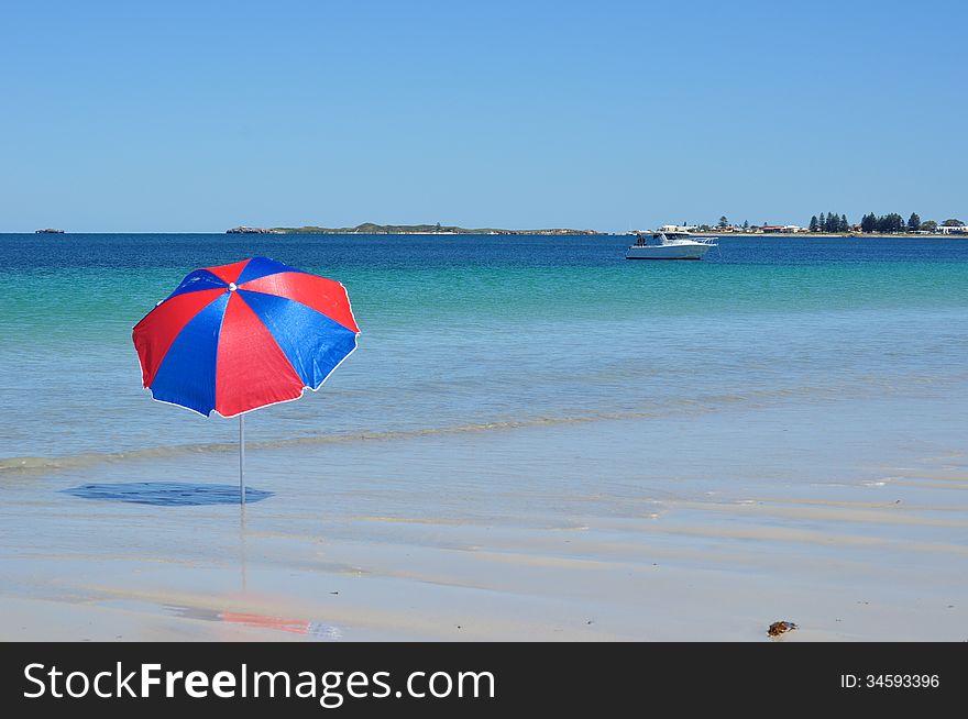 Umbrella by the sea with boat