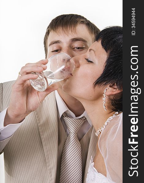 The groom and the bride drink water. White isolated.
