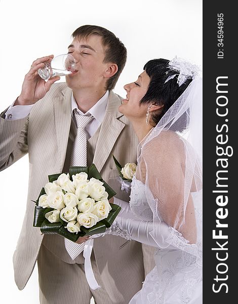 The groom and the bride drink water. White isolated.