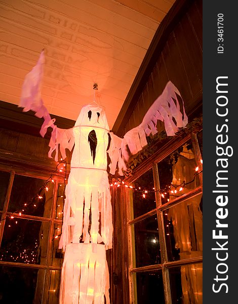 Fluttering white ghost halloween decoration in old room