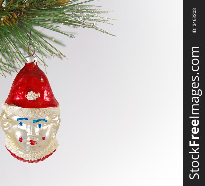 Closeup of an antique elf Christmas ornament on a white background.