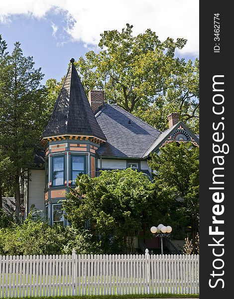 Colorful victorian house hiding in the trees. Colorful victorian house hiding in the trees