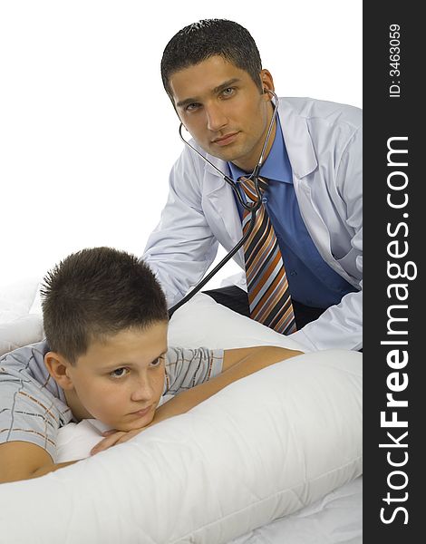 Male doctor examining a boy. Doctor looking at camera. They're on white background. Male doctor examining a boy. Doctor looking at camera. They're on white background.