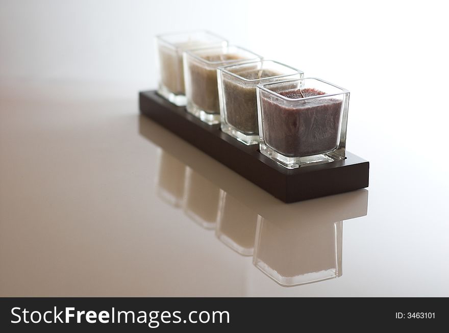 Four candles in a row and their reflection, shallow depth of field. Four candles in a row and their reflection, shallow depth of field