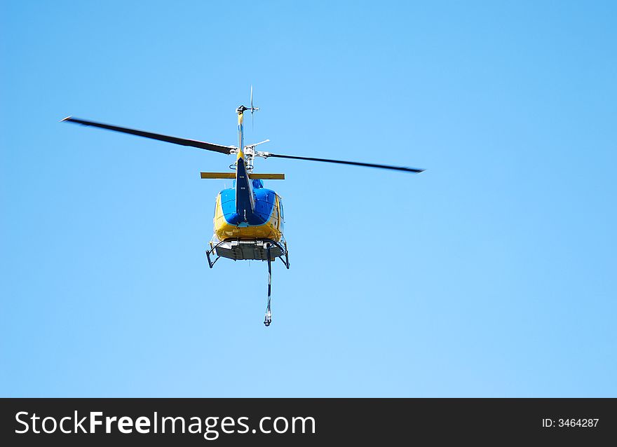 Helicopter flying low to provide airsupport for firemen on the ground in Los Angeles, California. Helicopter flying low to provide airsupport for firemen on the ground in Los Angeles, California
