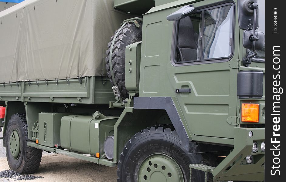 Military truck, side view, in a trade fair