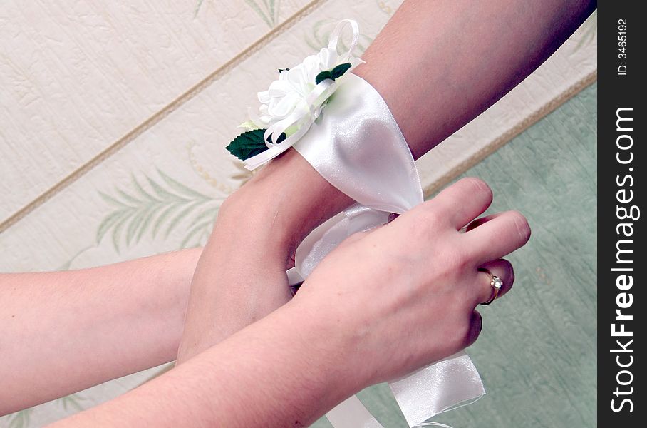 Clothing ribbon on the hand of bride
