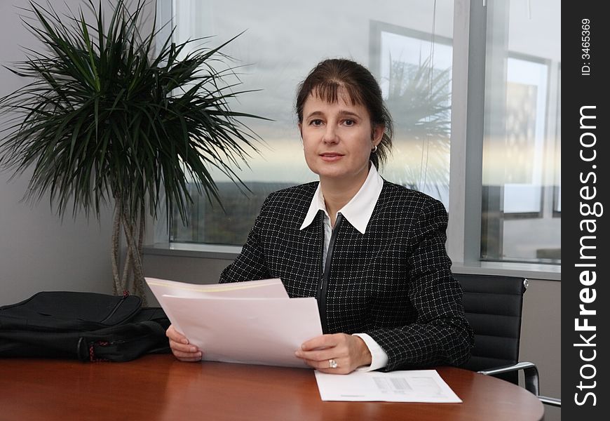 Business woman working with documents in her office. Business woman working with documents in her office