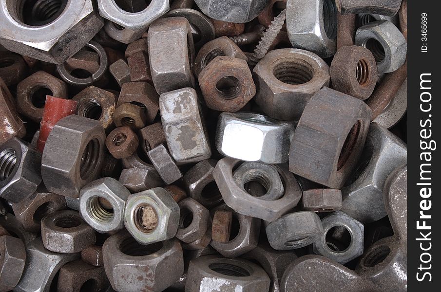 Technological metal background from the steel nuts. Technological metal background from the steel nuts