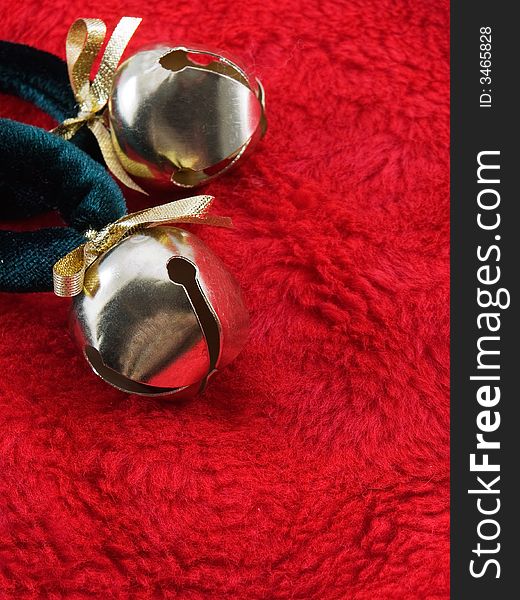 Gold christmas bells on a red plush fabric