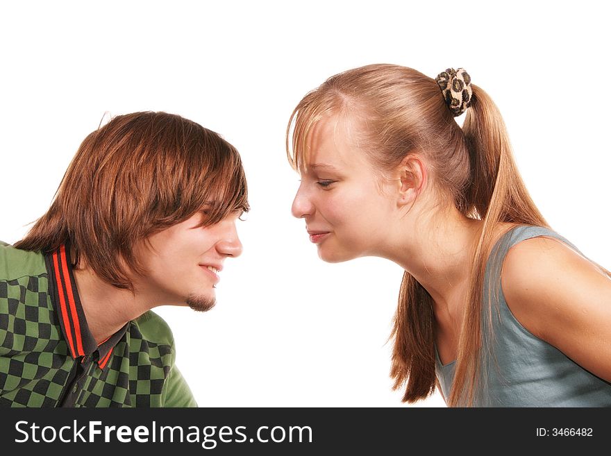 Attractive young woman and man face to face isolated over white background