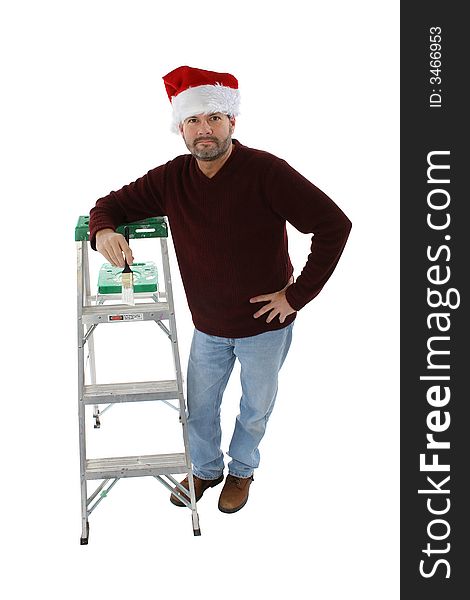 Man in santa hat leaning on ladder with white paint brush. Man in santa hat leaning on ladder with white paint brush