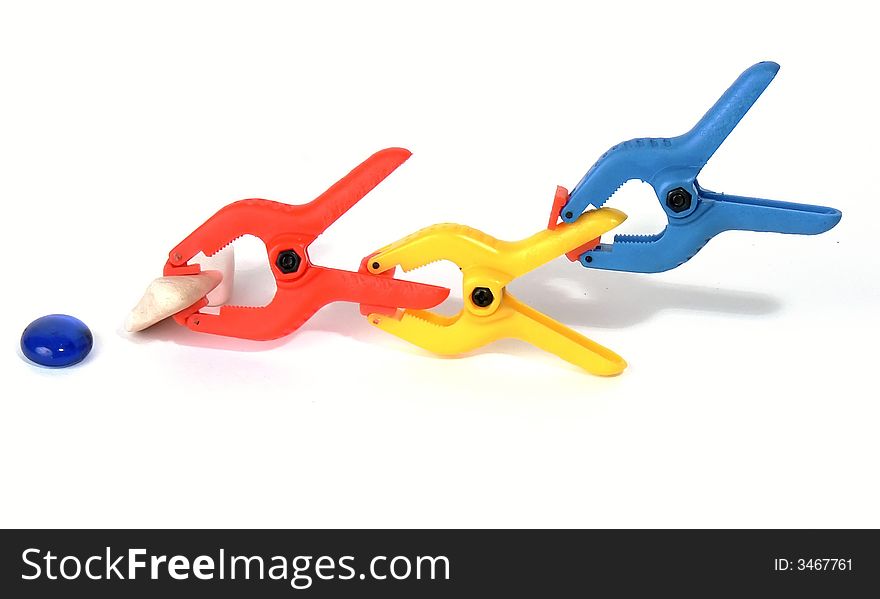 3 spring clips, colored clamps photographed on a white background. 3 spring clips, colored clamps photographed on a white background