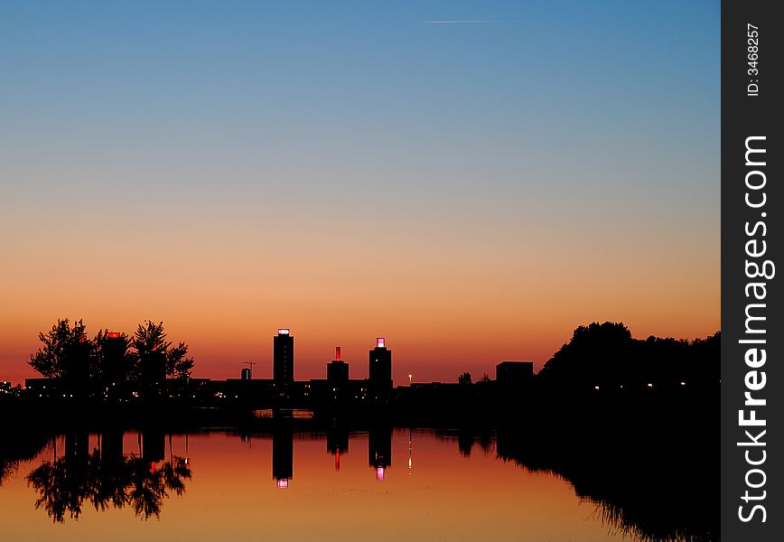 A moment after sunset skyline of Ypenburg with reflection in water. A moment after sunset skyline of Ypenburg with reflection in water.