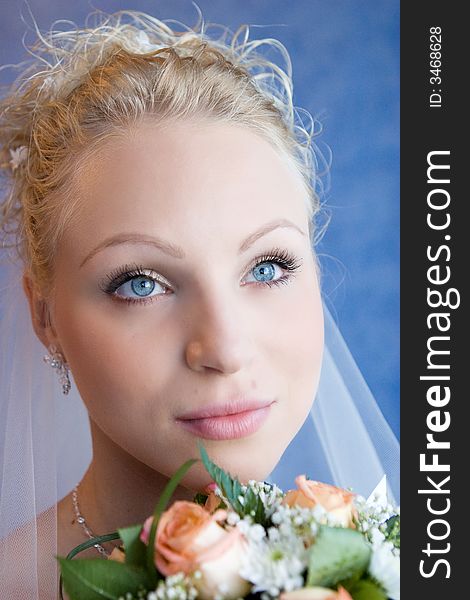 The bride holds a bouquet and pensively looks. The bride holds a bouquet and pensively looks