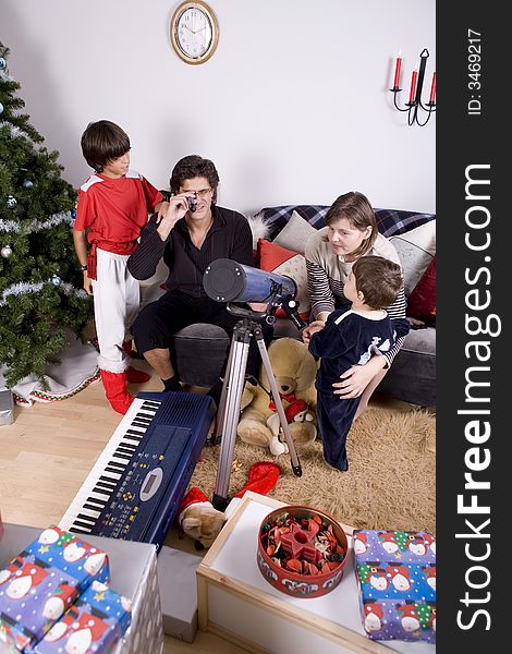 Happy family having fun and opening gift at christmas time. Happy family having fun and opening gift at christmas time