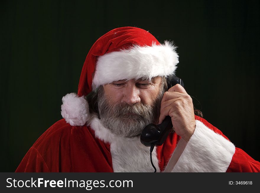 A young Santa with gray hair and beard having a good time