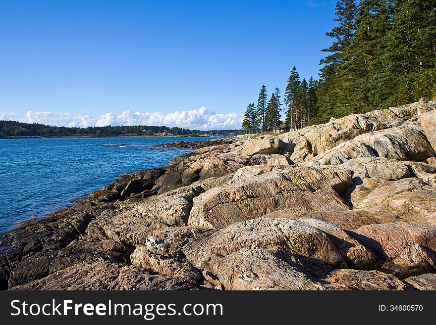 The rugged rocky coastline of Maine from a low perspective at the rocks. The rugged rocky coastline of Maine from a low perspective at the rocks.