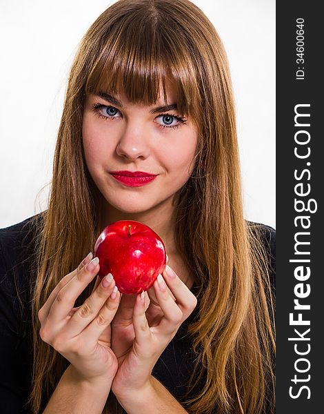 The pretty, young Girl and red apple. Isolated on white.