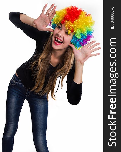Cheerful girl multi-colored wig. Isolated on white. Cheerful girl multi-colored wig. Isolated on white.