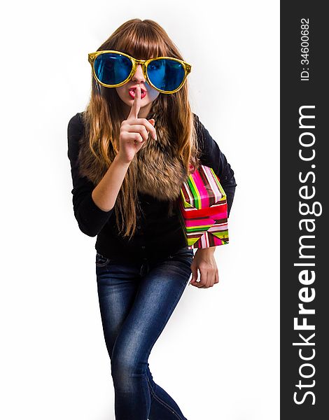 Cheerful woman with big sunglasses. Gift in a hand, isolated. Cheerful woman with big sunglasses. Gift in a hand, isolated.