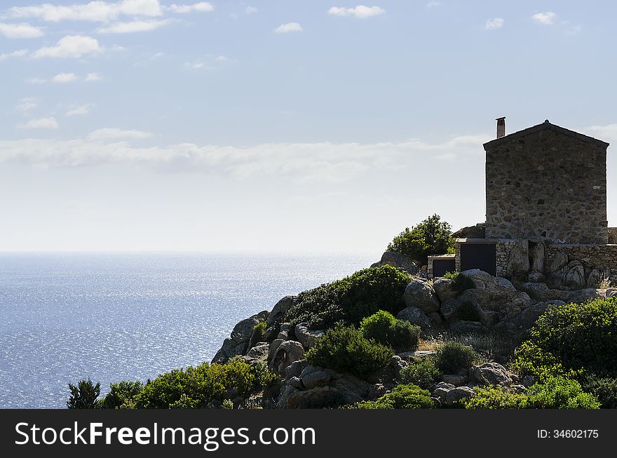 Stone house overlooking the sea. Blue sky with strong contrast.