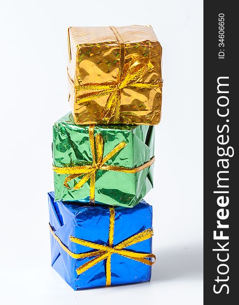 Multicolored decorative gifts on white background