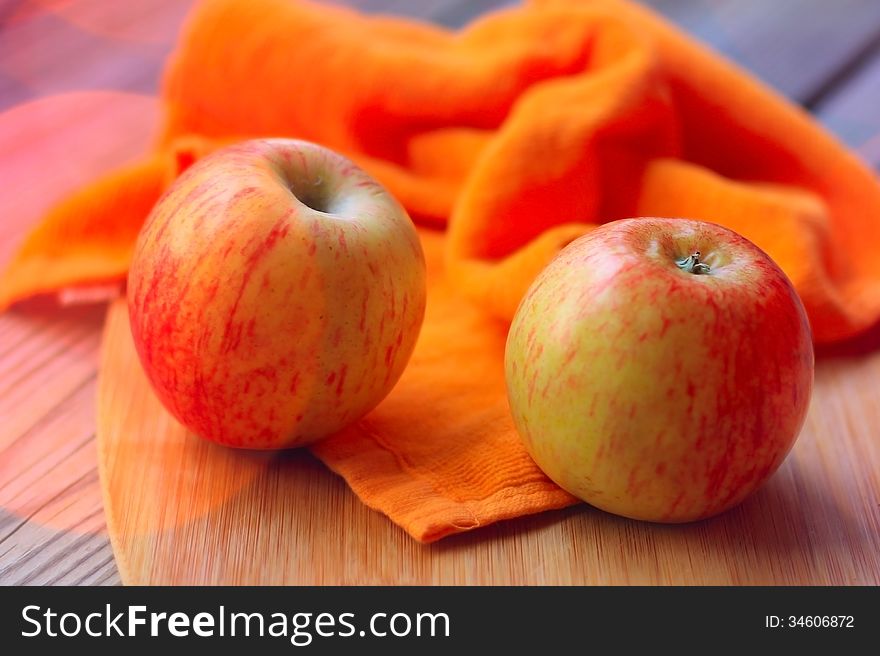 Red apples on wooden kitchen table