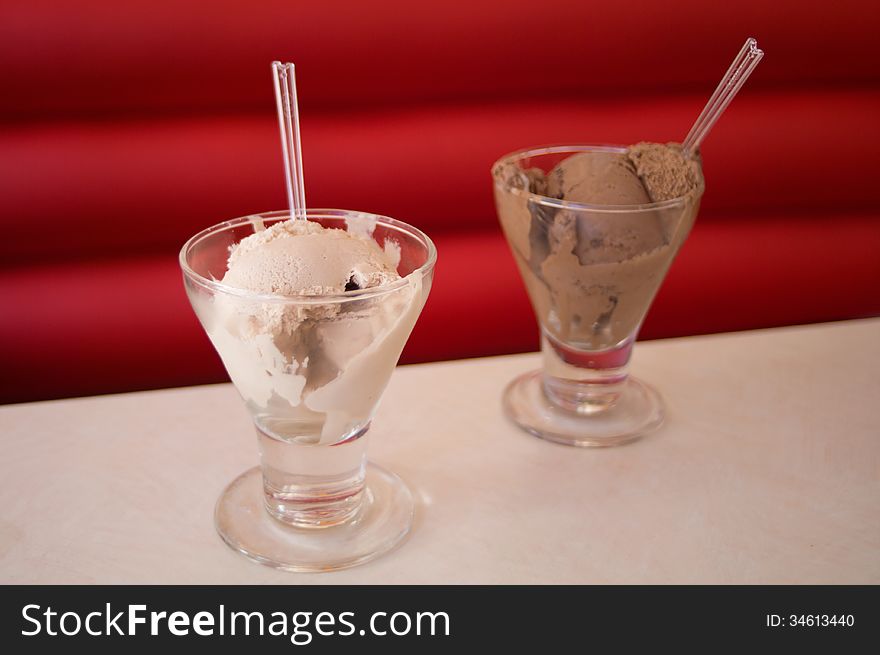 Two cups of different flavors of ice cream, vanilla and chocolate. Two cups of different flavors of ice cream, vanilla and chocolate.