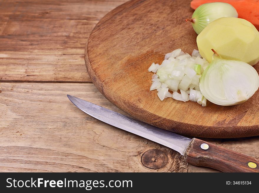 Chopped onion with a knife on a cutting board