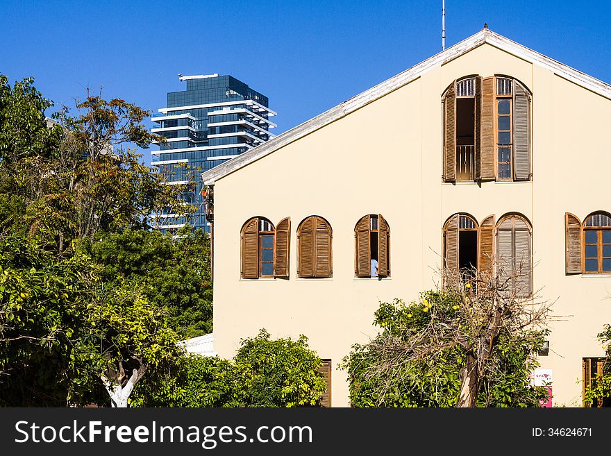 Beautiful old house on a background of a skyscraper