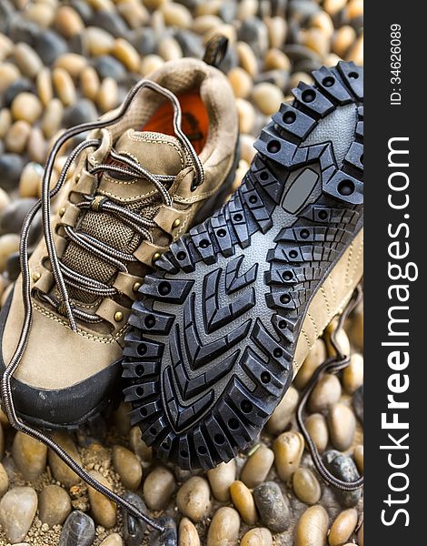 A pair of hiking shoes on cobble floor. A pair of hiking shoes on cobble floor