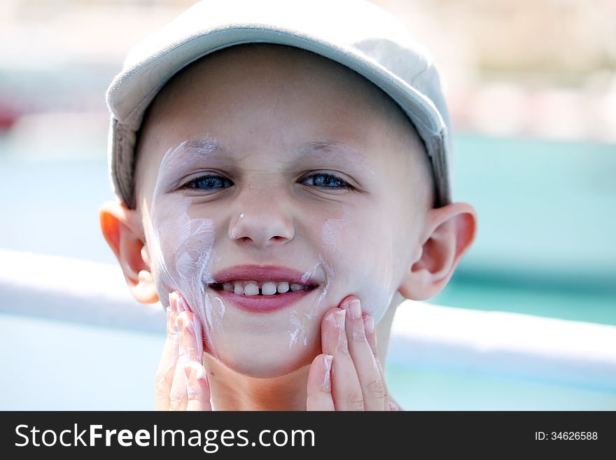 Cancer child slapping on sunblock for protection. Cancer child slapping on sunblock for protection