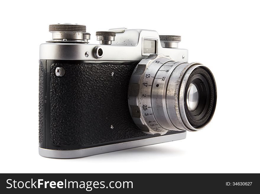 Old black metal camera with lens on white. Old black metal camera with lens on white