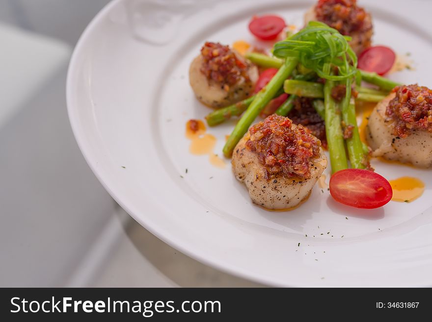 Grilled scallops on white plate