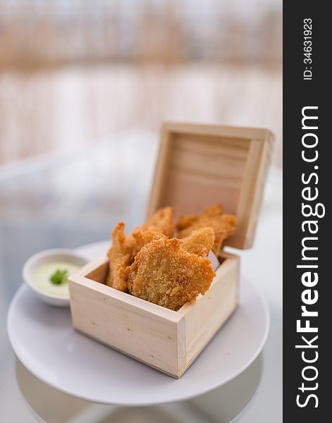 Crisp fish finger nugget in wooden box