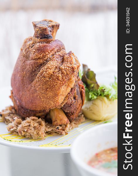 German roasted pork leg on white plate