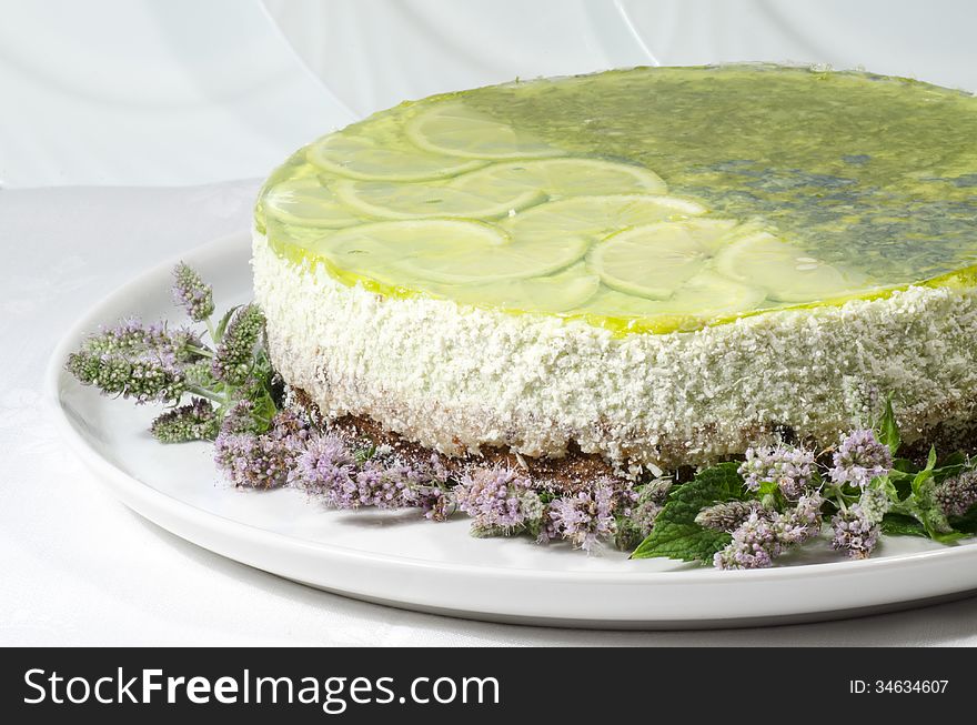 Lime cheesecake decorated with mint flowers