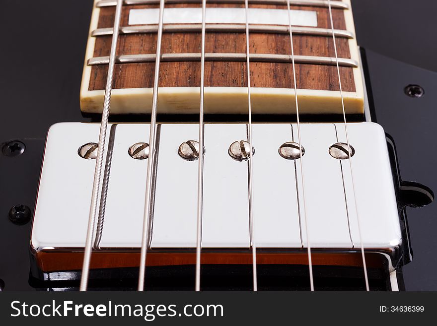 Detail of an electric guitar humbucking pickup. Detail of an electric guitar humbucking pickup