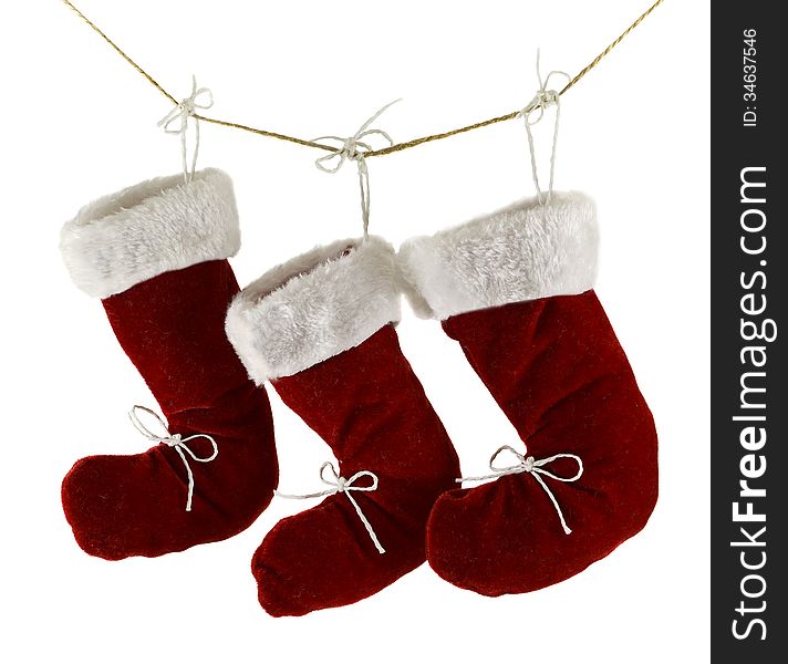 Three red Santa boots on string isolated on white. Three red Santa boots on string isolated on white