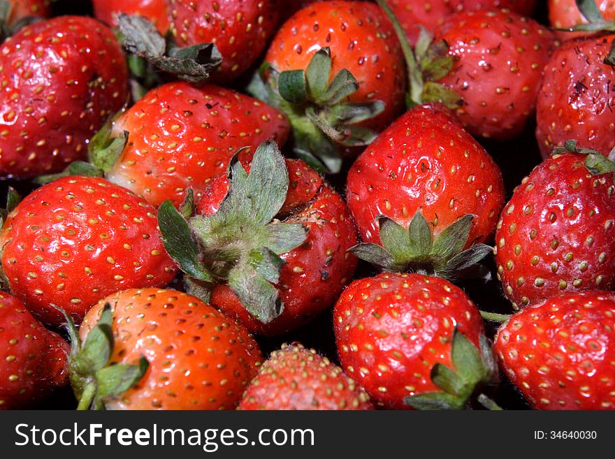 For background or design element, strawberry over blackbackground. For background or design element, strawberry over blackbackground