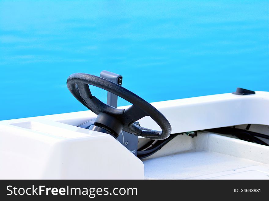 Racing boat steering wheel on the ocean