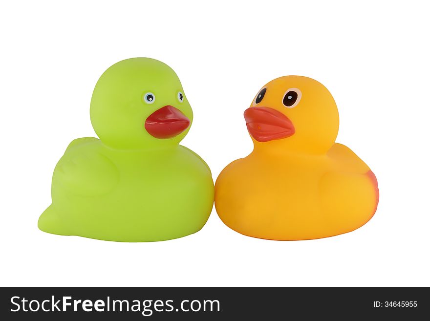 Couple of green and yellow rubber ducklings isolated on white backround. Couple of green and yellow rubber ducklings isolated on white backround
