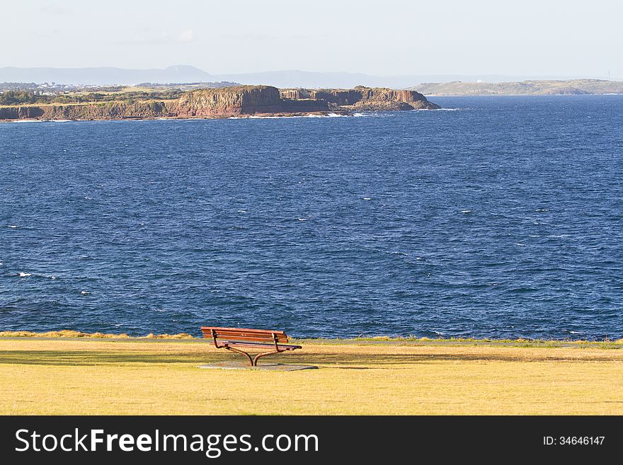 A beautiful beach view and park with a chair where you can see mountains. A beautiful beach view and park with a chair where you can see mountains.