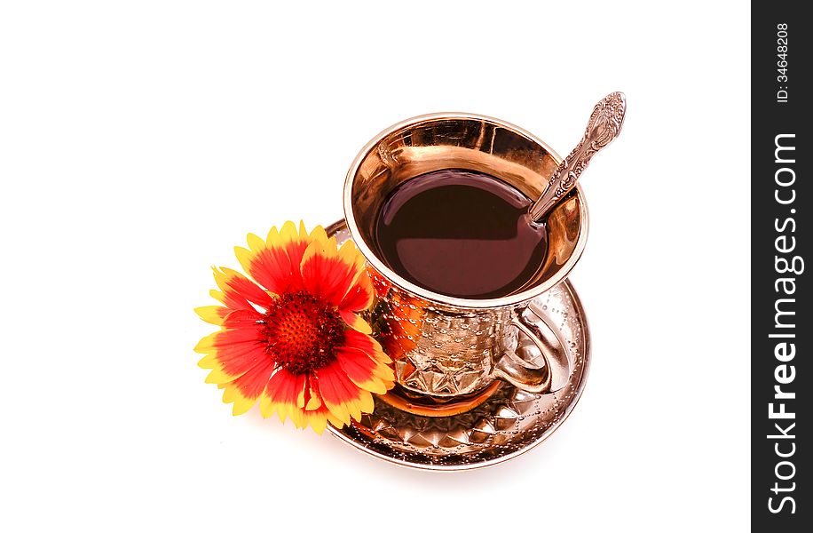 Cup of coffee on a saucer with a flower on white. Cup of coffee on a saucer with a flower on white