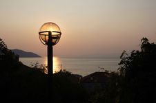 Sunset Over Sea With Light Bulb Over The Sun Royalty Free Stock Photography