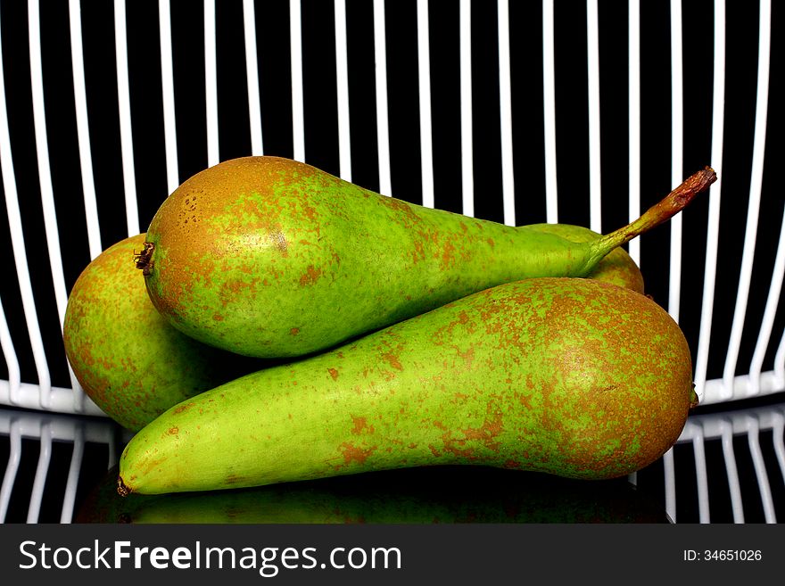 Three pears stacked, with net in background