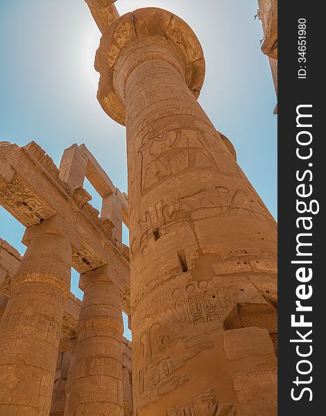 Huge columns in the Karnak Temple. Ancient Egyptian hieroglyphs on columns. Huge columns in the Karnak Temple. Ancient Egyptian hieroglyphs on columns