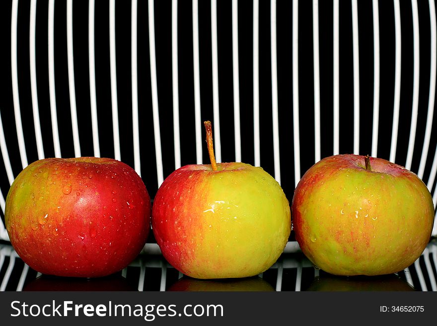 Three apples on a line, with net in background