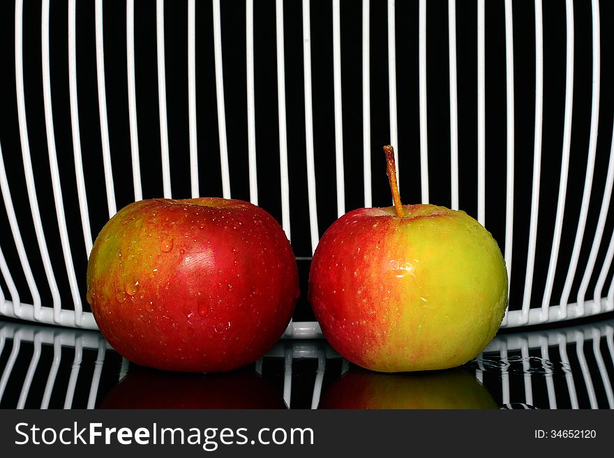 Three apples on a line, with net in background. Three apples on a line, with net in background